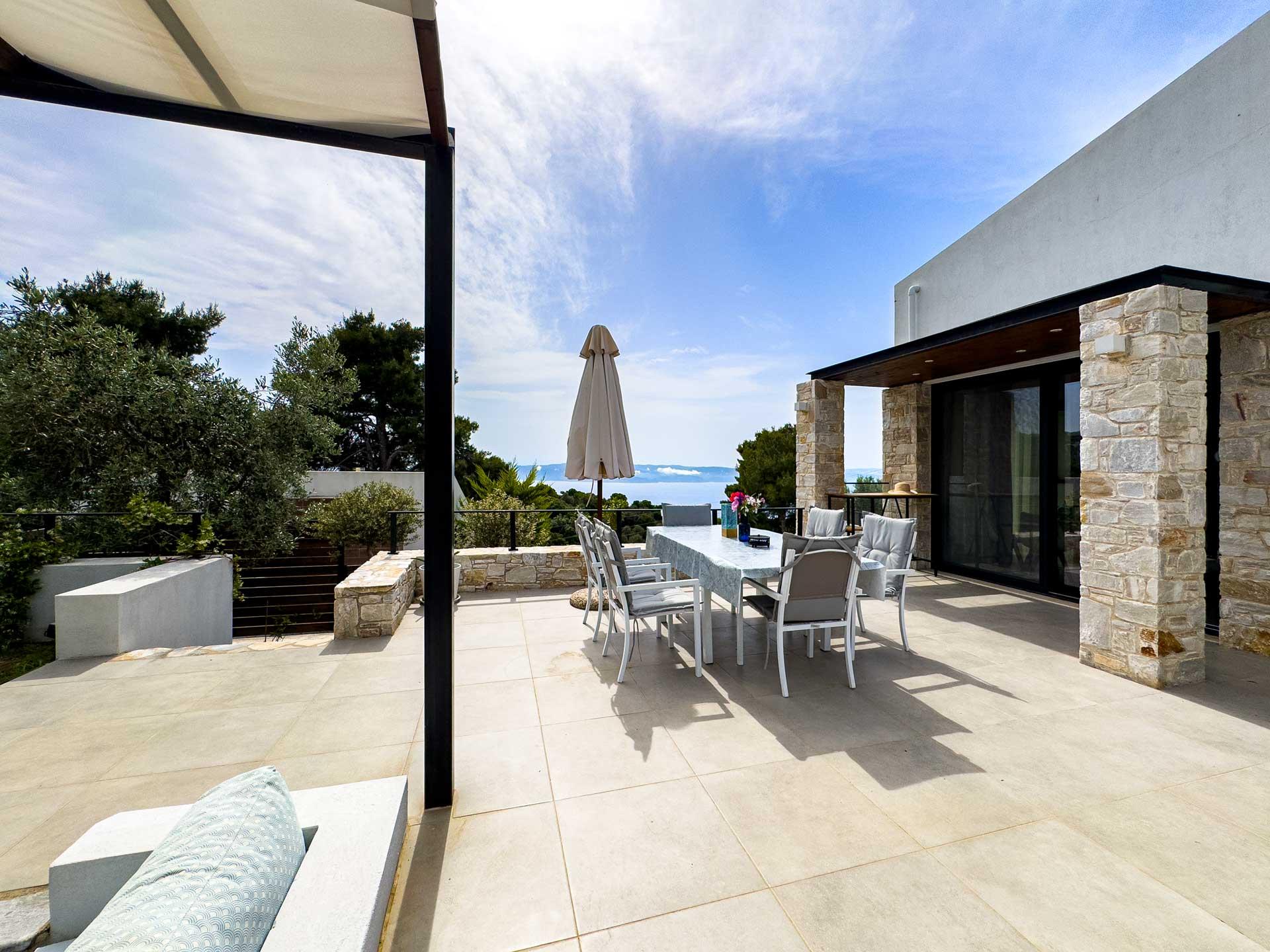 Outdoor terrace with Mediterranean views at Skiathos luxury villa